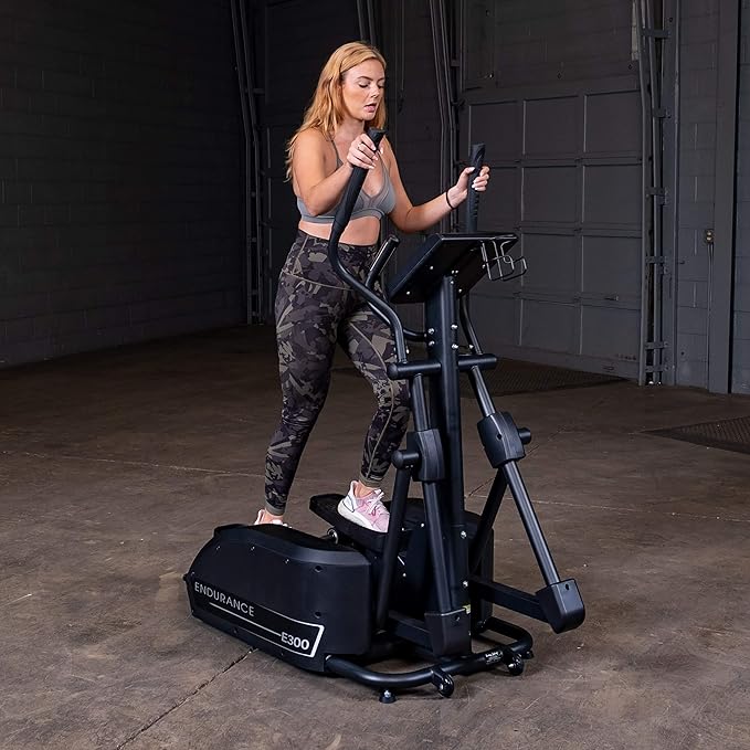 Body-Solid Endurance Elliptical E300 - side view displaying elliptical path and flywheel