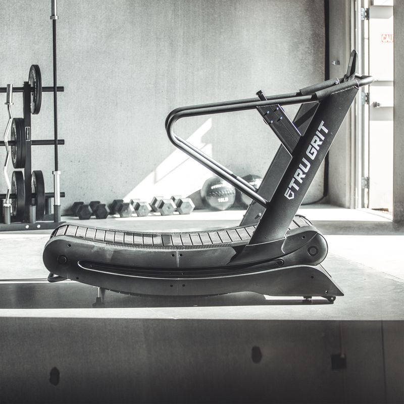 Tru Grit Grit Runner Curved Manual Treadmill - angled view showing handlebar and frame